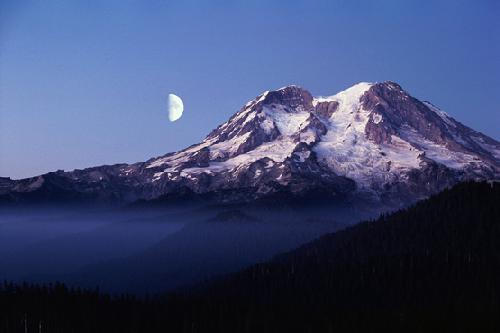 The moon rising over Mt. Ranier