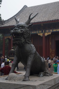Imperial qilin before a palace
      building
