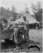 MESS Sgt Johnson unloading corn he swiped from ITies.jpg